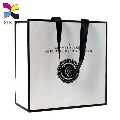 Custom wholesale recycled printed paper bag with luxury logo for cloth